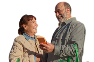 A couple with a woollies bag and a phone smiling