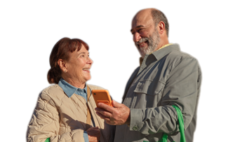 A couple with a woollies bag and a phone smiling