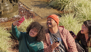 A group of friends taking a selfie on an orange phone